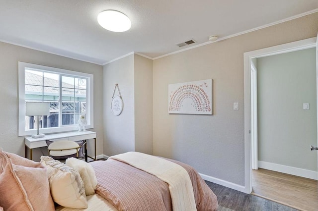 bedroom with hardwood / wood-style flooring and crown molding