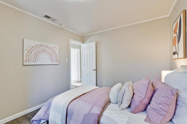 bedroom with crown molding and hardwood / wood-style floors