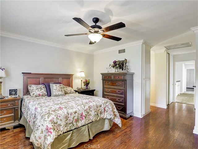 bedroom featuring dark wood-type flooring, ceiling fan, and ornamental molding