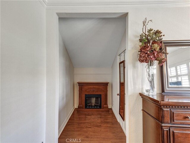 hall featuring hardwood / wood-style floors and ornamental molding