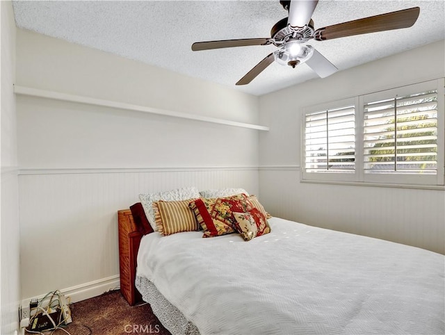 carpeted bedroom with a textured ceiling and ceiling fan