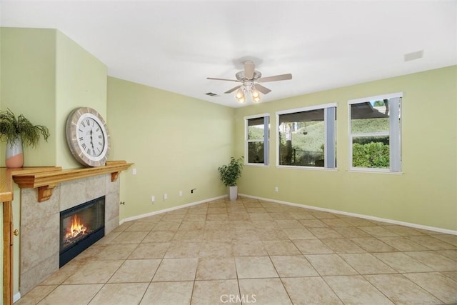 unfurnished living room featuring ceiling fan, a fireplace, and light tile patterned floors