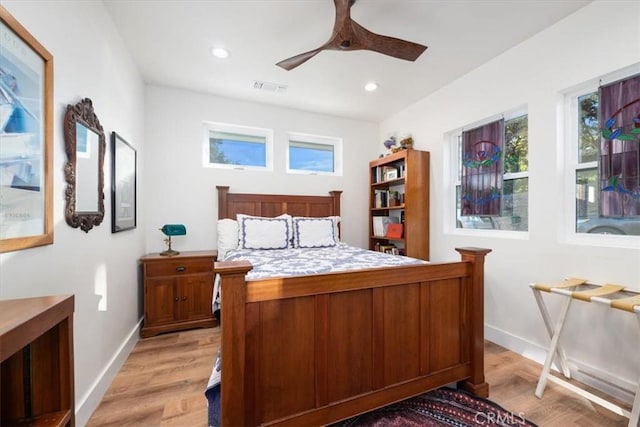 bedroom with light hardwood / wood-style flooring and ceiling fan