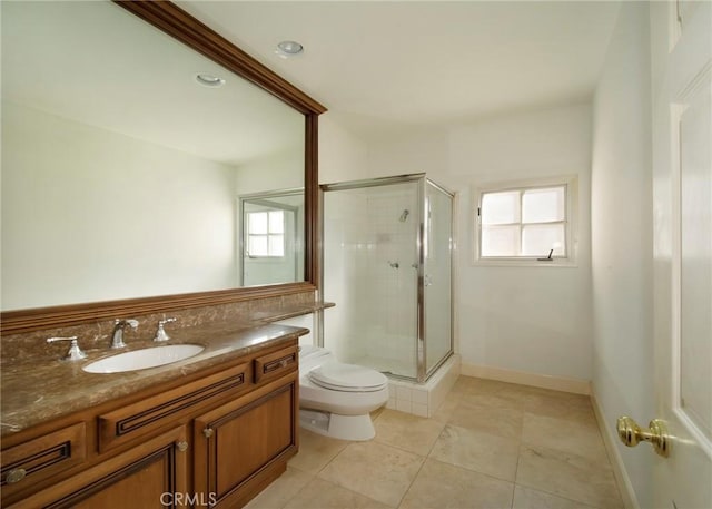 bathroom with vanity, toilet, a shower stall, and tile patterned flooring