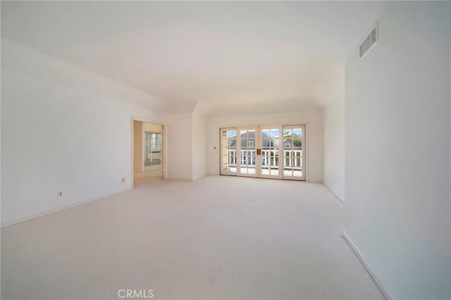 carpeted spare room featuring visible vents