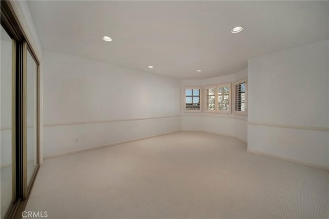 empty room with recessed lighting, carpet, and baseboards