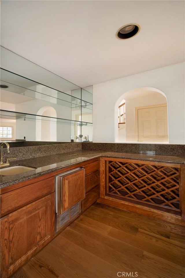 interior space with a sink and wood finished floors