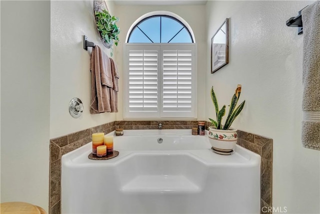 bathroom featuring a washtub