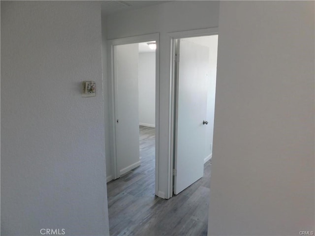 corridor with hardwood / wood-style floors