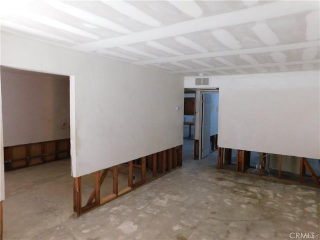 unfurnished room with concrete flooring