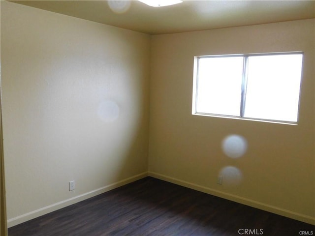 unfurnished room with dark hardwood / wood-style floors