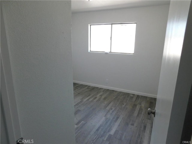 empty room featuring dark wood-type flooring