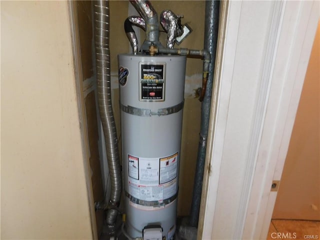 utility room featuring water heater