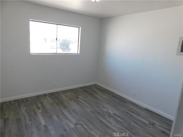 empty room with dark hardwood / wood-style flooring