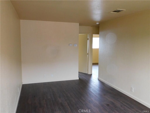 empty room featuring dark wood-type flooring