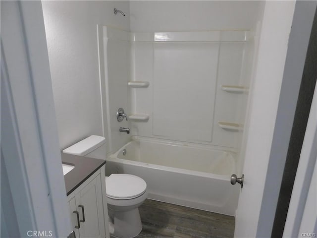 full bathroom featuring toilet, vanity, wood-type flooring, and shower / bath combination