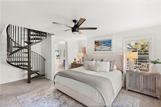 carpeted bedroom featuring ensuite bath and ceiling fan