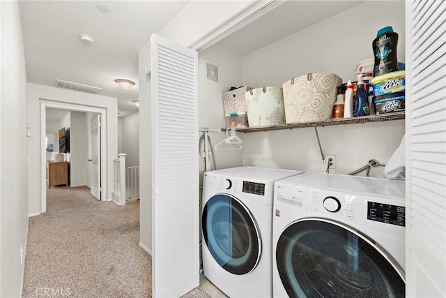 washroom with light colored carpet and washing machine and dryer