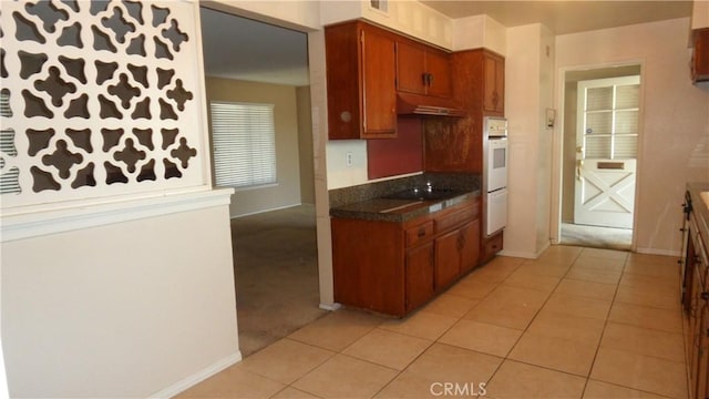 kitchen with light tile patterned floors and black electric cooktop