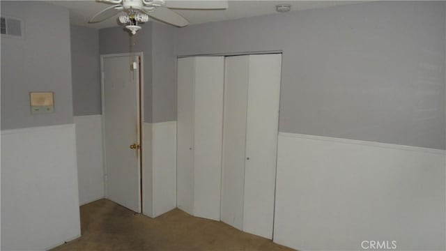 unfurnished bedroom featuring ceiling fan, carpet, and a closet