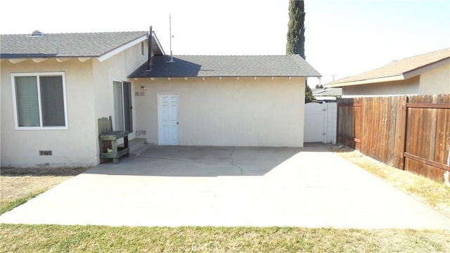 back of property with a patio