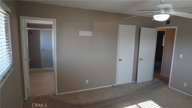 unfurnished bedroom with ceiling fan and light colored carpet