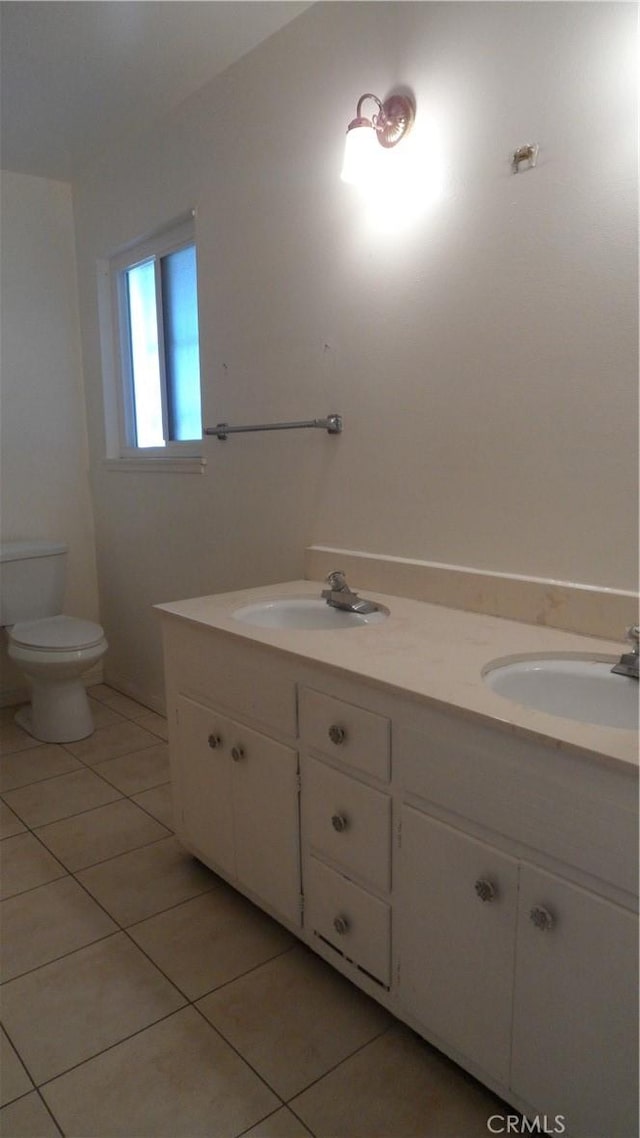 bathroom featuring toilet, tile patterned floors, and vanity