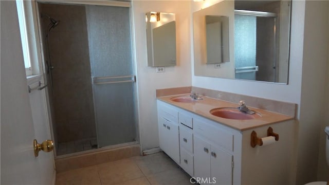 bathroom featuring toilet, tile patterned floors, an enclosed shower, and vanity