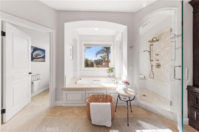 bathroom with tile patterned floors and separate shower and tub