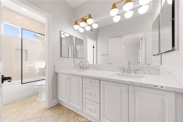 full bathroom featuring toilet, vanity, tile patterned flooring, and shower / bath combination with glass door