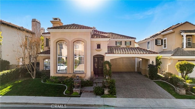 mediterranean / spanish house with a garage