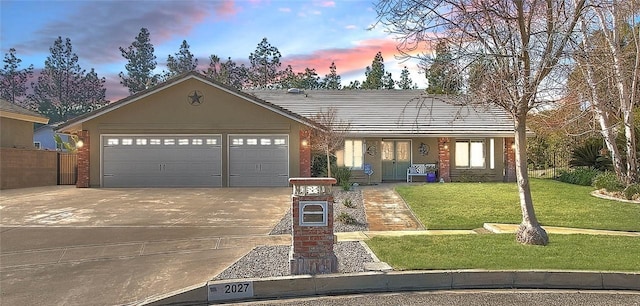 view of front facade with a garage and a lawn