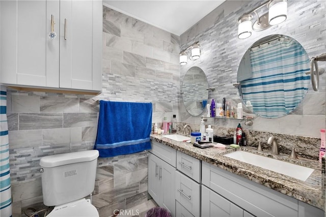 bathroom featuring tile walls, toilet, vanity, and walk in shower