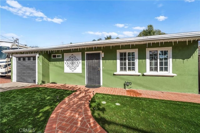 ranch-style home featuring a front yard and a garage