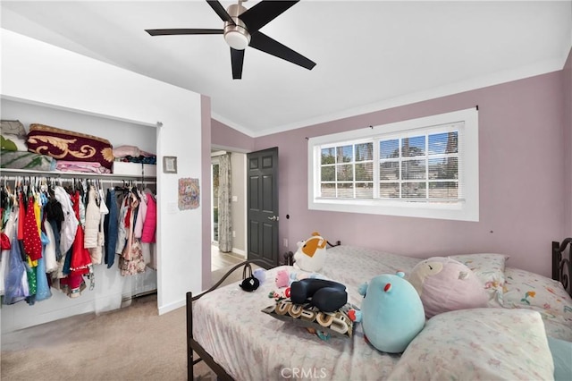 bedroom featuring ceiling fan, a closet, lofted ceiling, light colored carpet, and ornamental molding