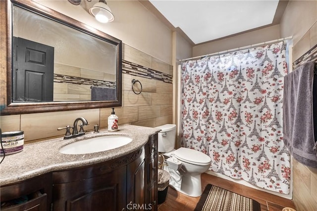 bathroom featuring toilet, hardwood / wood-style flooring, vanity, and curtained shower