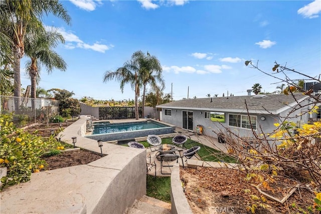 view of pool featuring an outdoor fire pit and a patio