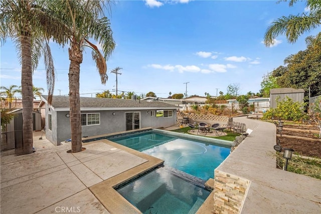 view of pool featuring an in ground hot tub and a patio