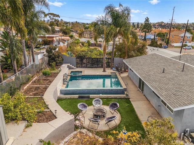 view of swimming pool with a patio area and an outdoor fire pit