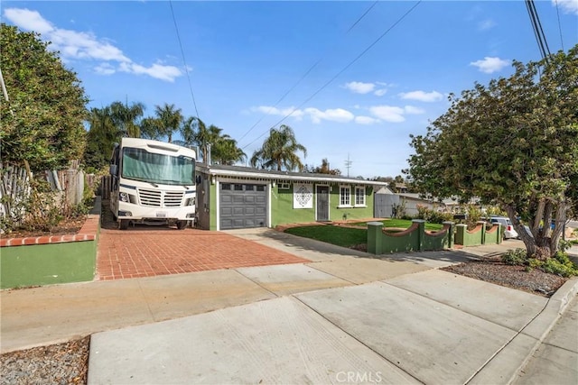 view of front of property with a garage and a front lawn