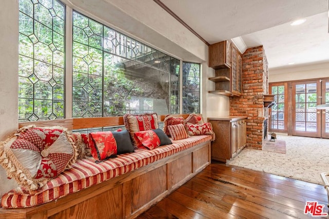 living room with dark hardwood / wood-style flooring and ornamental molding