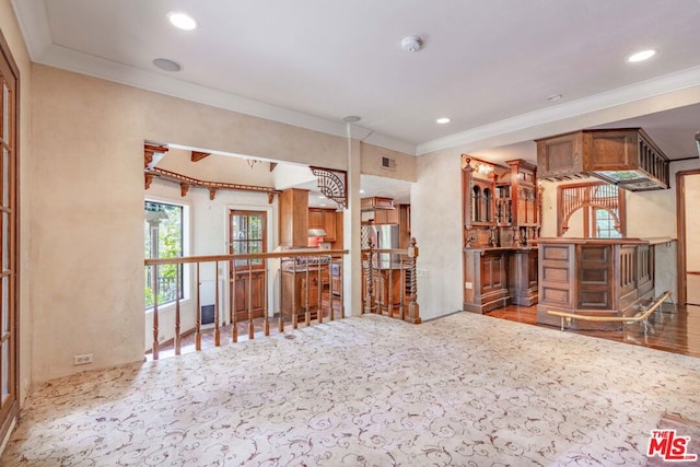 interior space featuring bar and ornamental molding