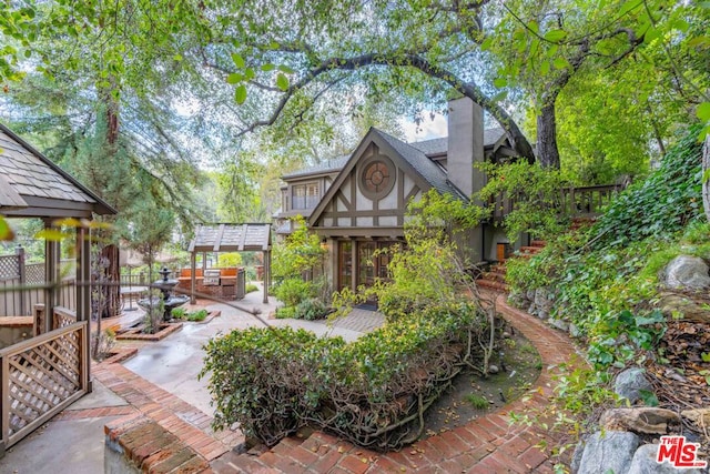 view of home's community with a patio area and a pergola