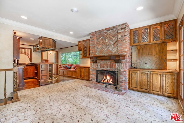 living room with a brick fireplace, sink, and crown molding