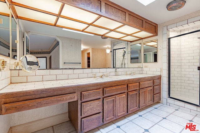 bathroom with a shower with door and vanity