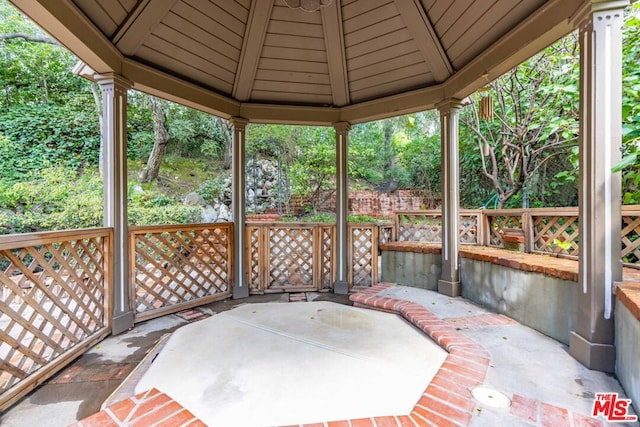 unfurnished sunroom featuring vaulted ceiling and wood ceiling