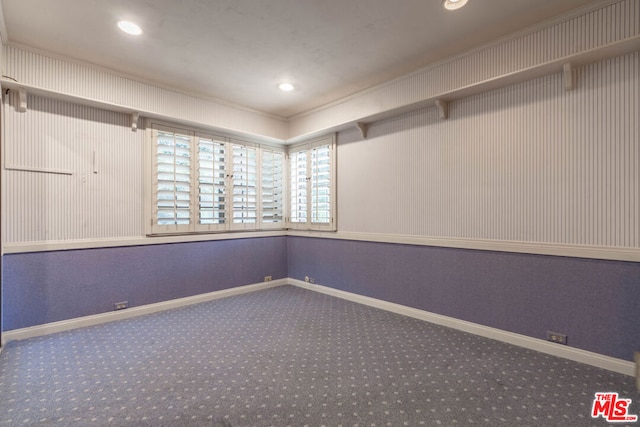 carpeted spare room with crown molding