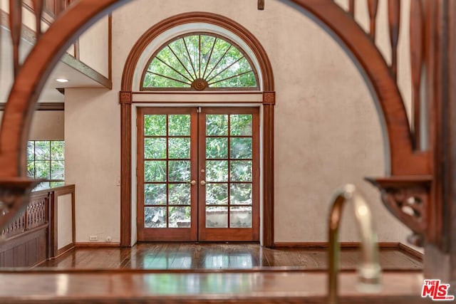 doorway with french doors and light wood-type flooring