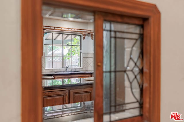 interior details featuring sink and backsplash