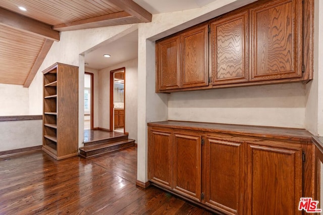 interior space with lofted ceiling with beams, dark wood-type flooring, and wooden ceiling